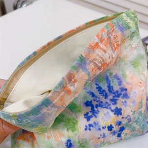Detail of floral canvas cosmetic bag showing zipper closure and soft inner lining