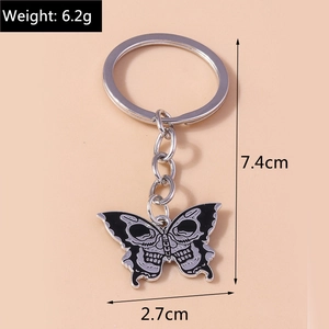 Detailed view of skull butterfly keychain with size measurements 7.4cm and weight 6.2g