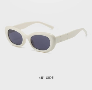Detail of retro oval sunglasses featuring cream frames and signature four-stitch temple design