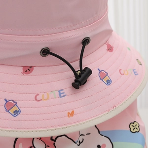 Detail of pink summer sun hat with adjustable drawstring and cute cartoon print