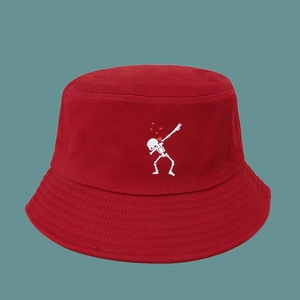 Detail of red bucket hat featuring skeleton dab embroidery and reinforced brim stitching