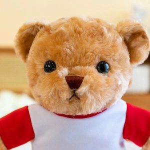 Adorable oso de peluche con camiseta de uniforme escolar blanca y roja de béisbol