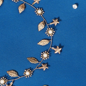 Detail of bridal hairband featuring gold leaf, pearl sun flowers and starfish charms