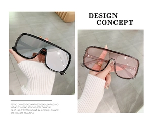 Detail of oversized shield sunglasses with trendy mirrored lenses and resin frame