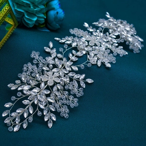 Detailed close-up of handmade bridal headband with crystals and silver floral accents