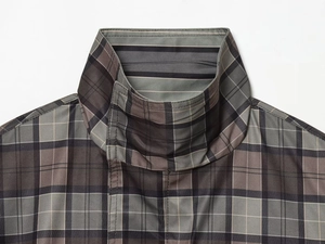 Detail shot of a plaid jacket collar showing grey and brown checkered fabric texture