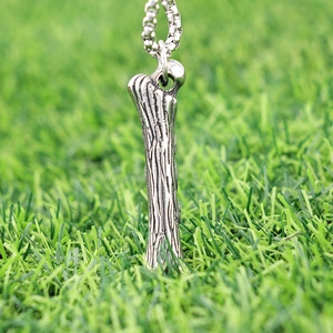 Vintage stainless steel bone pendant necklace with realistic texture on green grass