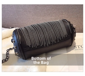 Macro detail of black cylindrical bag featuring silver chain fringe and metal studs