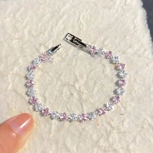 Detail of silver clasp bracelet with alternating pink and white square-cut zircons
