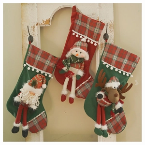 Detail of 3D plush Christmas stockings with Santa, Snowman and Reindeer on wood