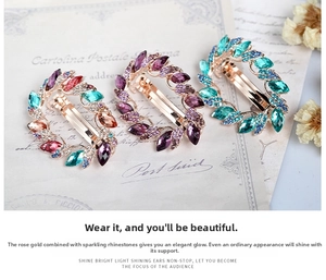 Macro view of rose gold leaf hair clips set with colorful crystal rhinestones