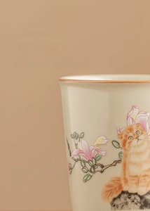 Close-up of Ru kiln ceramic cup with cute cat and magnolia flower exquisite painting