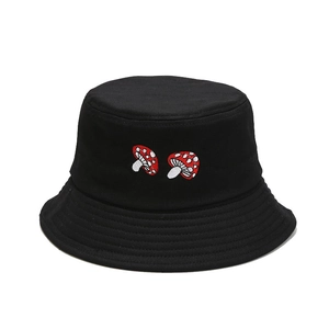 Women's black cotton bucket hat with minimalist red mushroom embroidery on a white background