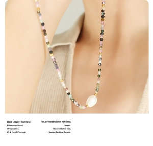 Detail of colorful stone beaded necklace with a white freshwater pearl in 18k gold plating