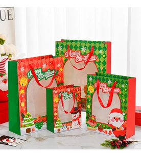 Detail of Christmas gift bags with transparent windows and festive character patterns