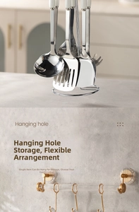 Close-up of stainless steel kitchen utensils with white heat-resistant handles and hanging holes