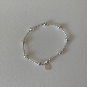 Minimalist 925 sterling silver beaded bracelet with sleek geometric tubes and round charm