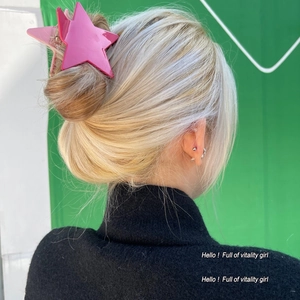 Pink star-shaped hair claw clip for women shown on model for elegant updo styling