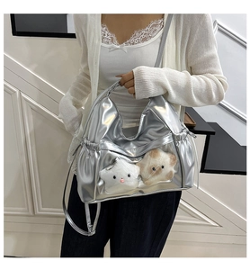 Silver metallic shoulder bag featuring a clear PVC window with star plush toys inside