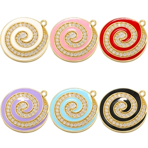 Macro shot of colorful enamel spiral charms with gold metal base and clear zircons
