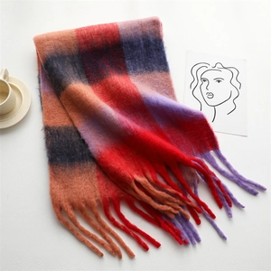 Detail of soft rainbow plaid cashmere-like scarf with thick fringe and mohair texture