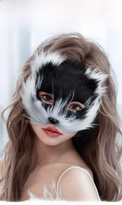 Detailed view of a black and white faux fur fox mask worn by a female model for cosplay
