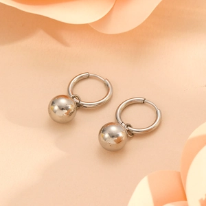Detailed close-up of stainless steel sphere pendant earrings with round hoop clasp