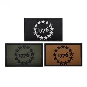 Detailed embroidery of 1776 tactical patches in black, green, and tan with 13 stars