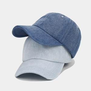 Close-up of vintage denim baseball caps showing stitching detail and twill fabric texture