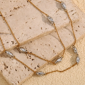Irregular pendant necklace in two-tone 18K gold plated steel on layered marble slabs