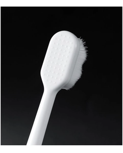 Macro shot of ultra-fine white nano toothbrush bristles with non-slip handle grip