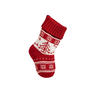 Red and white knitted Christmas stocking with festive tree and snowflake patterns