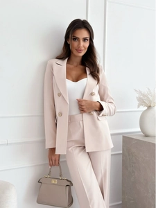 Detail of beige double-breasted blazer set with gold buttons and tailored pants