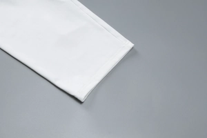 Detailed close-up showing high-quality double stitching on the white sleeveless top and shorts