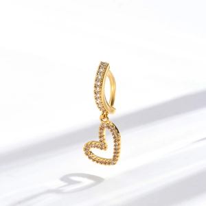 Golden heart navel ring with sparkling zircon inlays on a clean white background