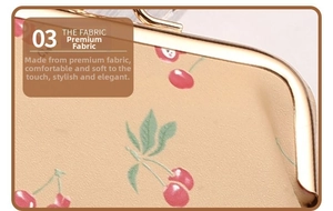 Detail of premium PU leather with cherry print and golden metal ball clasp closure