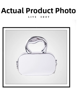Detail of silver mirror finish handbag with unique sculptural handle and chain strap