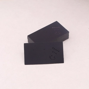 Detail of matte black thick paper earring display card with gold Thank You and smile icon