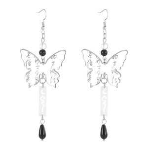 Detail of silver hollow butterfly earrings with artistic calligraphy and black teardrop charms