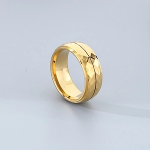 Macro detail of golden geometric rhombus facets on a polished stainless steel ring band