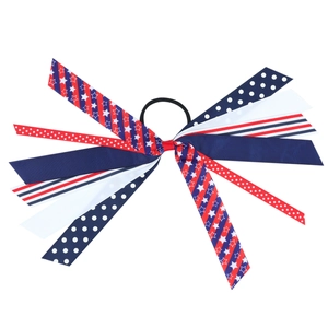 Close-up of patriotic American flag ribbon hair tie with red white and blue star patterns