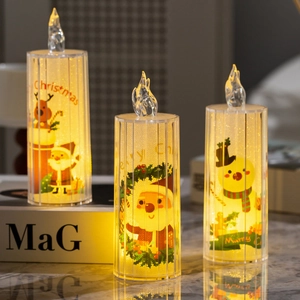 Three transparent Christmas LED crystal candles with warm yellow light on a marble table