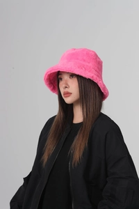 Detail view of the thick bright pink faux fur bucket hat with soft plush texture