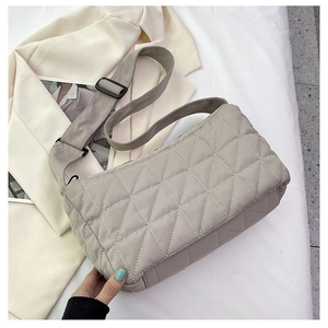 Detail of grey quilted corduroy tote showing wide adjustable strap and soft fabric texture