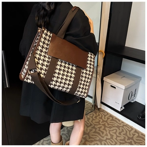 Houndstooth tote bag with brown leather flap shown on model in a modern home interior