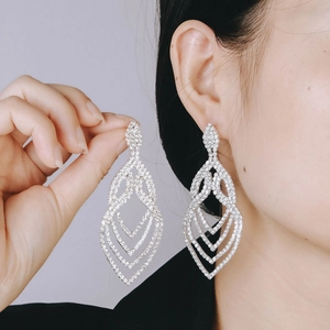 Detail of silver long drop tassel earrings with sparkling cubic zirconia on a model