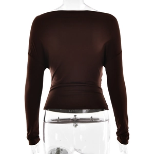 Rear view detail of dark brown slim-fit long sleeve top with draped fabric texture