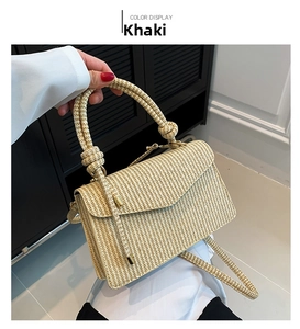 Detail view of khaki woven PU crossbody bag featuring knotted top handle and golden hardware