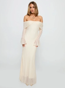 Detail of delicate lace texture on off-white off-shoulder dress with flare sleeves