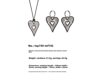 Detailed view of large heart jewelry set showing stainless steel texture and dimensions
